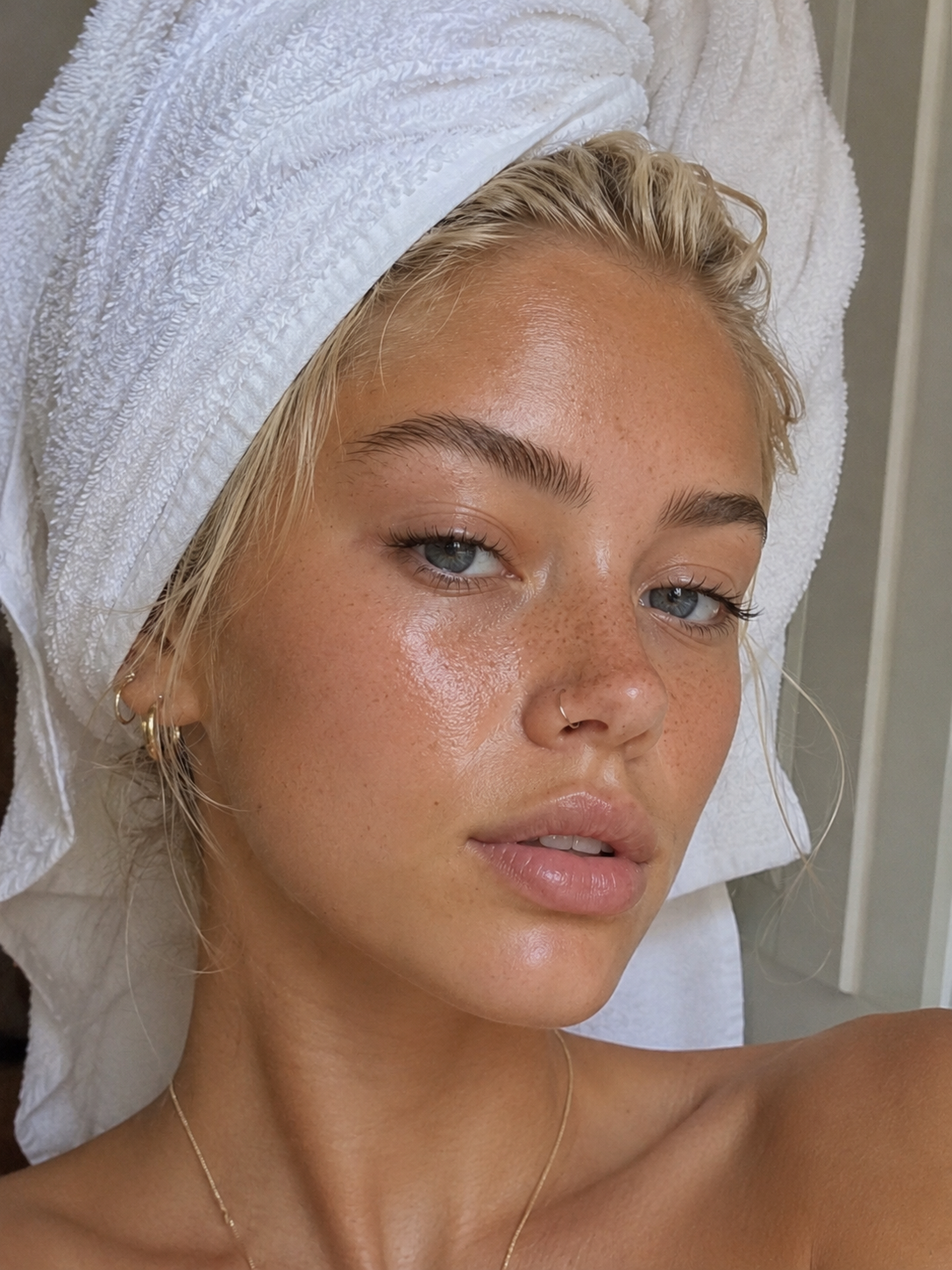 Close-up portrait of glowing, freckled skin after a shower